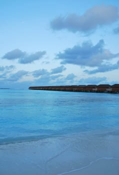 beautiful seascape with water villas in Maldivian Island after sunset