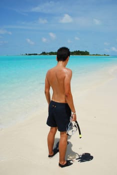 man getting ready to go snorkeling in a tropical island