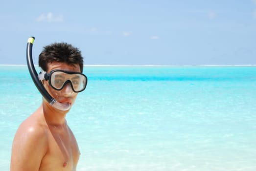 closeup of a young snorkeler man in a tropical island
