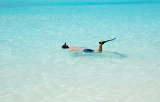 young man snorkeling in a tropical island