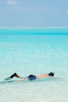 young man snorkeling in a tropical island