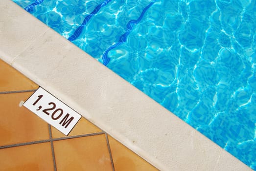 close-up photo of a 1.2m pool depth sign at the swimming pool