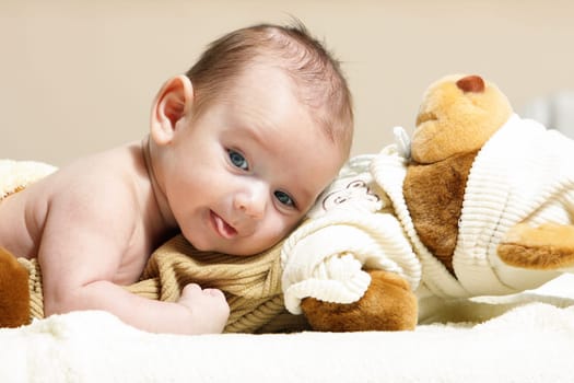 newborn lying on the cute toy bear