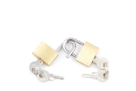 two golden padlocks and keys on white background