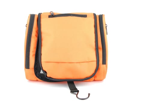 closed orange toiletry bag isolated on white background