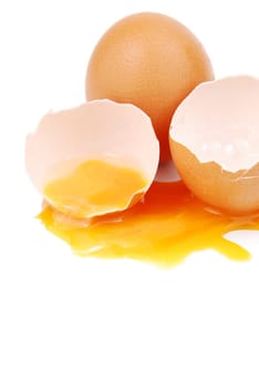 broken egg with the yolk and white oozing out isolated on white background