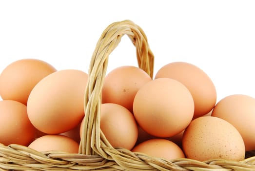close-up of eggs in a traditional wicker basket isolated on white background