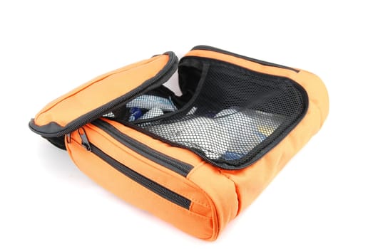 open orange toiletry bag isolated on white background