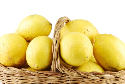 close-up of lemons in a traditional wicker basket isolated on white background
