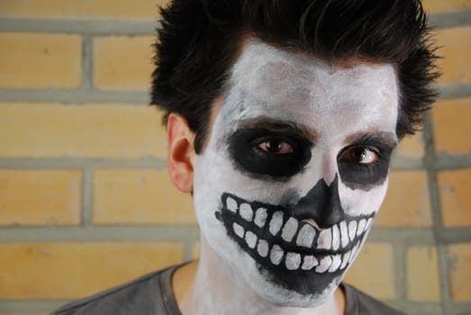 portrait of a creepy skeleton guy perfect for Carnival (brick wall background)