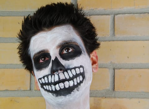 portrait of a creepy skeleton guy perfect for Carnival (brick wall background)