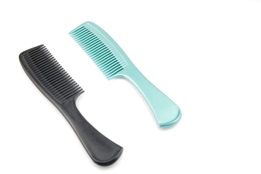 green and black plastic combs isolated on white background
