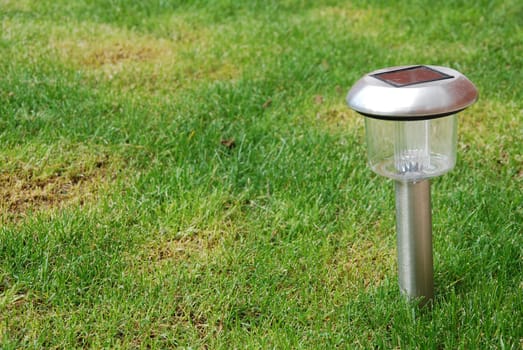 close-up of a solar garden light on green grass