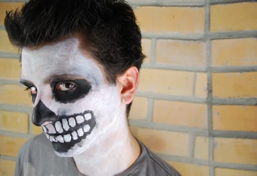portrait of a creepy skeleton guy perfect for Carnival (brick wall background)