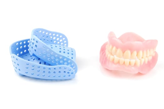 acrylic denture and acrylic trays isolated on white background
