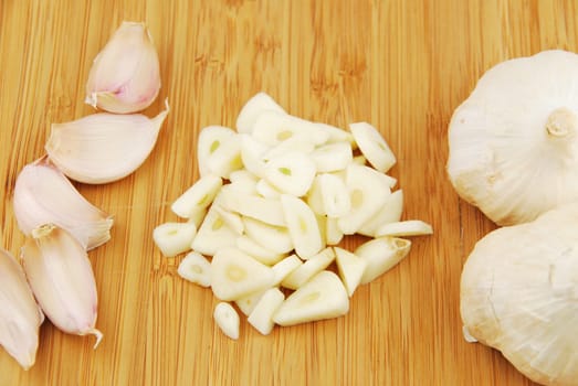 all, chopped and slices of garlic on a wooden cutting board