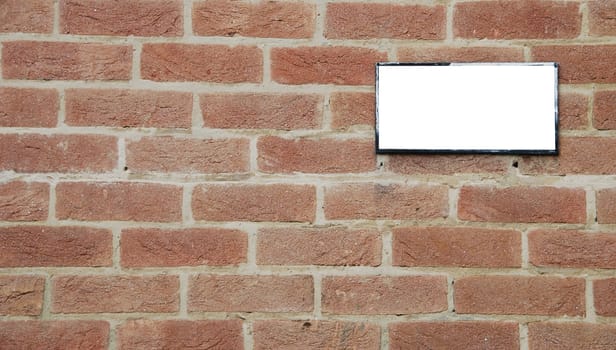 empty billboard on a beautiful brick wall building