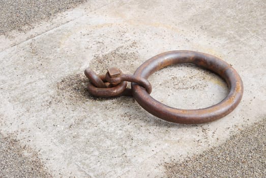 old and rusty mooring ring for ships on dock