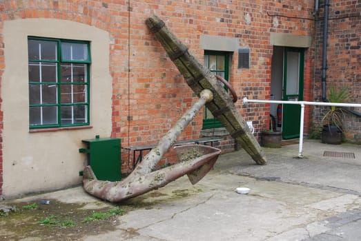 old and heavy anchor used to attach a ship to the bottom of the sea