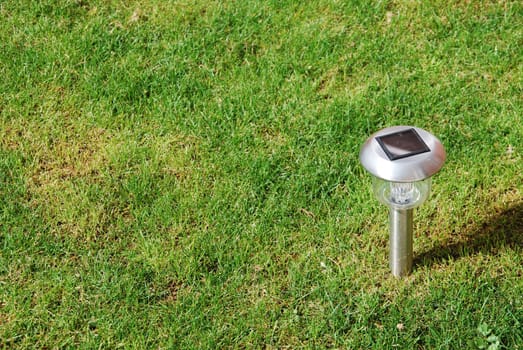 close-up of a solar garden light on green grass