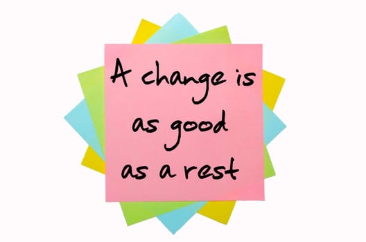 text "A change is as good as a rest"" written by hand font on bunch of colored sticky notes"