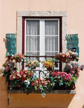 typical balcony of a residential window building with flowers in Lisbon, Portugal