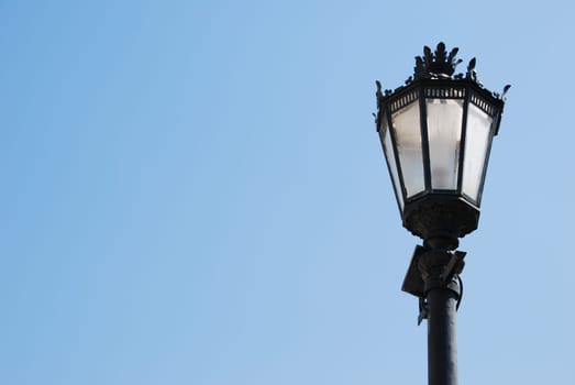 vintage lamp post against blue sky background