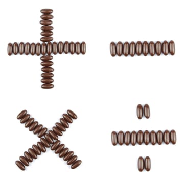 beautiful collection of arithmetic operations (multiplication, division, addition, subtraction) with chocolate candies (isolated on white background)