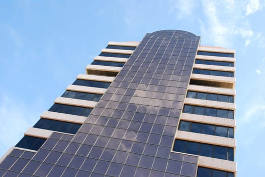 modern office building against blue sky background