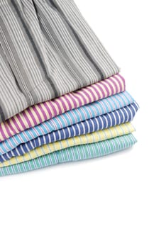 pile of stripped boxer shorts (male underwear) isolated on white background