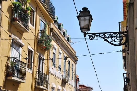 beautiful and traditional view of antique building and lamp in Lisbon, Portugal (river tagus background)