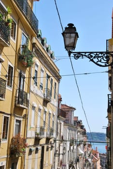 beautiful and traditional view of antique building and lamp in Lisbon, Portugal (river tagus background)