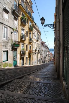 beautiful and traditional view of antique building and lamp in Lisbon, Portugal (river tagus background)