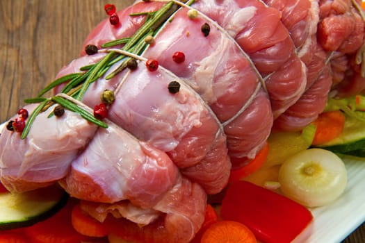 roast of beef with fresh vegetables ready to cook