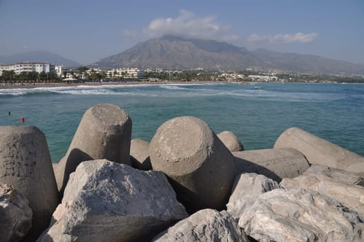 Puerto Banus beach from stone pier in Marbella, Spain