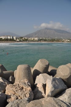 Puerto Banus beach from stone pier in Marbella, Spain