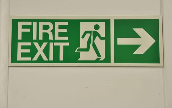 green and white fire exit sign (guidance to wayout)