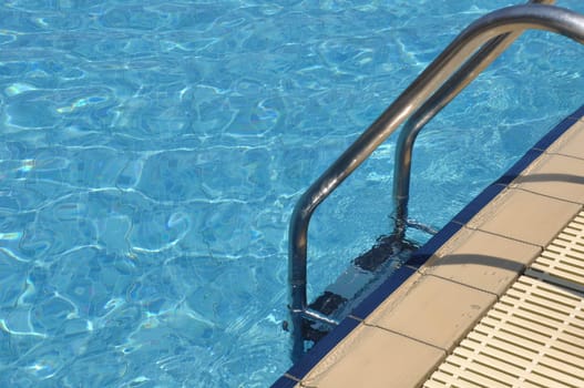 vibrant swimming pool side with ladder