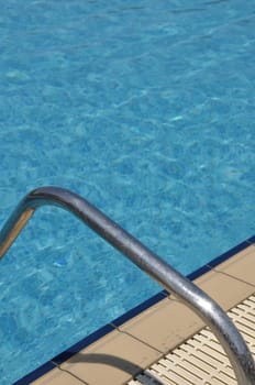 vibrant swimming pool side with ladder