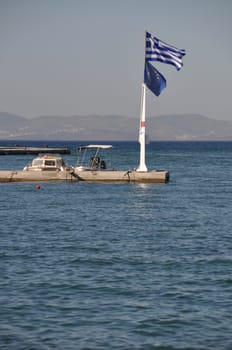 Greece and EU flags at Kos harbour (seascape view)