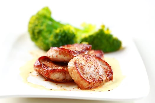 Medaillon of pork fillet with fresh green vegetable