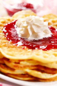 Waffles with fresh strawberry jam and whipped cream