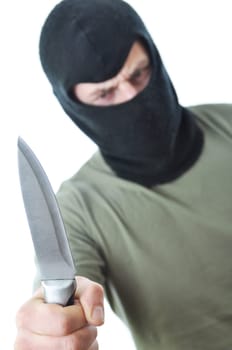 Bandit in black balaclava with knife in hand isolated on white background