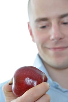 Young man eating fresh apple isolated on white background