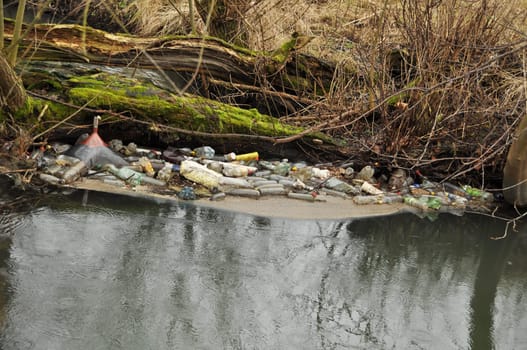 bottles and trash in the wild river