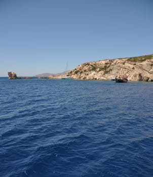beautiful desert or uninhabited island in Greece with sailing/cruising boats