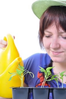 young woman watering plants with watering can isolated on white background
