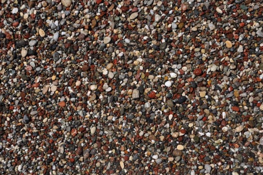 little and colorful stones at the beach (background or texture)