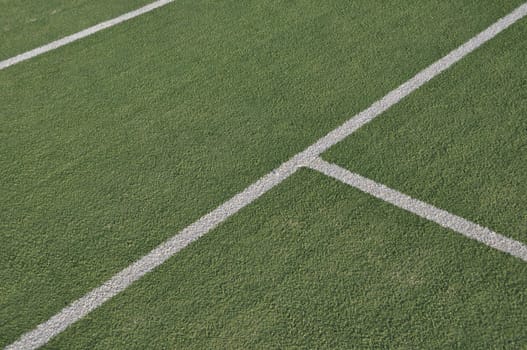 white lines on an outdoor tennis court (artificial grass)
