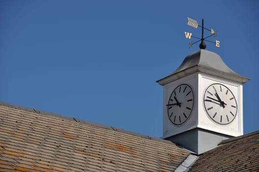 clock tower with weather vane on top of a building in Gloucester, England